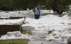 Hail as deep as two feet lies in the front yards of home along Logan Avenue between Platte Avenue and Bijou Street after a storm hit Colorado Springs, Colo., Monday, Aug. 29, 2016. Colorado Springs has dispatched snow plows to clean up after a powerful storm dumped heavy hail across the city. City spokeswoman Kim Melchor tells The Gazette she does not know how many plows were sent out, but crews are "pretty busy" after Monday afternoon's storm. (Christian Murdock/The Gazette via AP)
